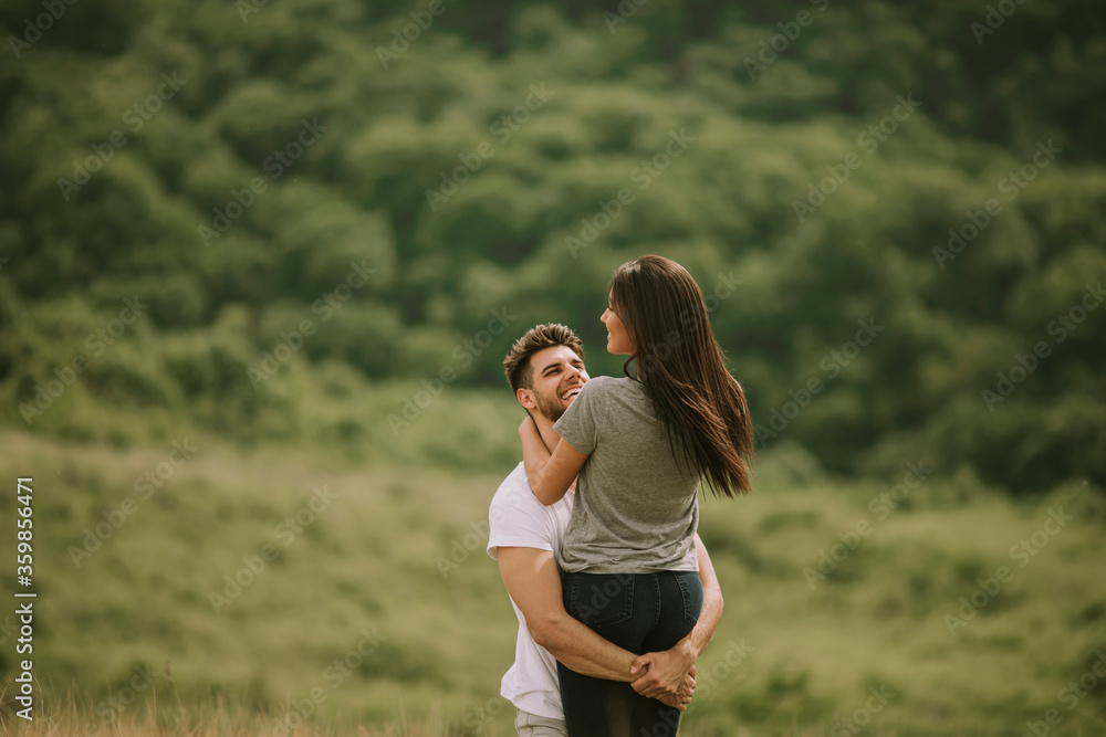 Pretty young couple in love outside in spring nature Pretty young couple in love outside in spring nature