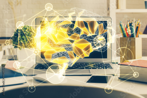 Double exposure of work space with computer and human brain drawing hologram. Brainstorm concept.