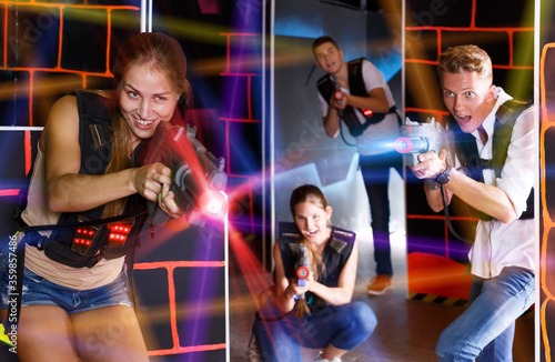 team of young people playing laser tag