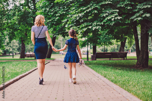 mother and daughter walking in the park © Ekaterina