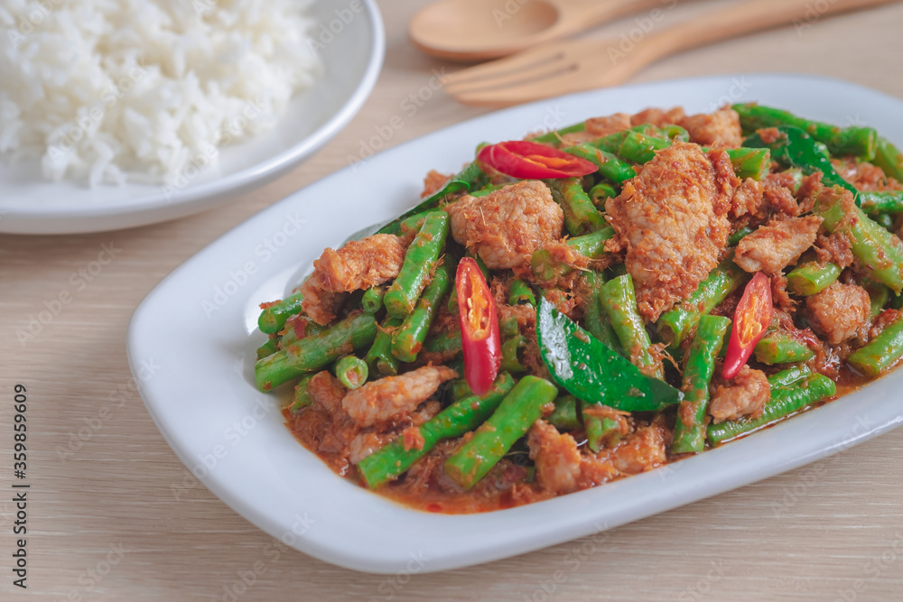 Stir fried pork with yard long bean and red curry paste served with rice, Thai food