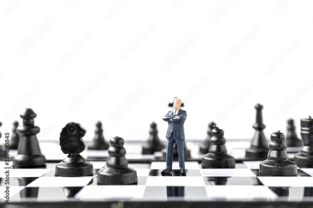 Miniature people Businessman standing on chessboard , Business and Competition Concept