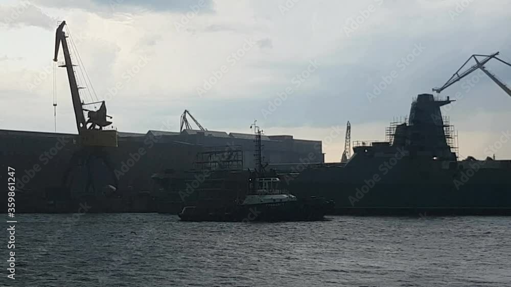 Russia, Saint Petersburg, June 19, 2020: strong storm, rain and thunderstorms are raging in the seaport. Ships and cranes in the port. Russia, Saint Petersburg, June 19, 2020: strong storm, rain and thunderstorms are raging in the seaport. Ships and cranes in the port.
