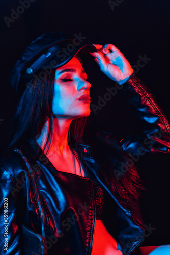 stylish Portrait of a young girl in a leather jacket and cap
