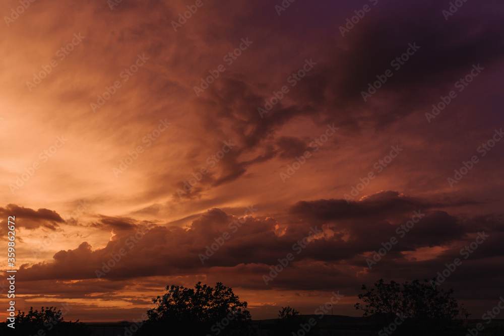 Beautiful sky with orange clouds in sky at sunset