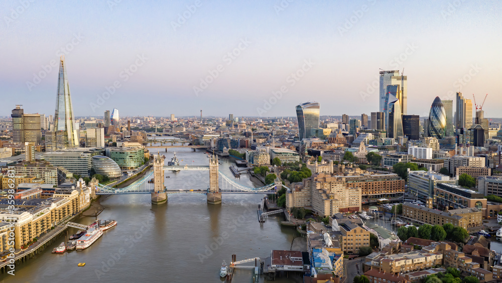 Tower Bridge and the River Thames at dusk with City Hall, The Shard and London City in the background. London England. Aerial view of London city centre