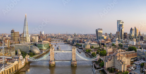 Aerial drone photograph of Tower Bridge and the River Thames at dusk with City Hall, The Shard and London City in the background. London England.  © Chris