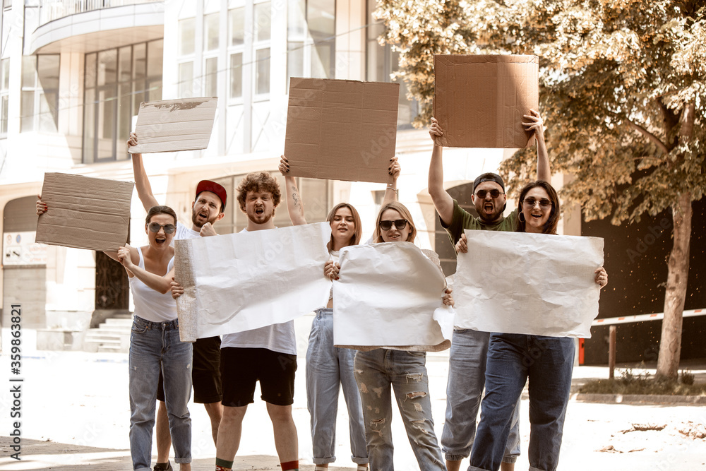Diverse group of people protesting with blank sign. Protest against ...