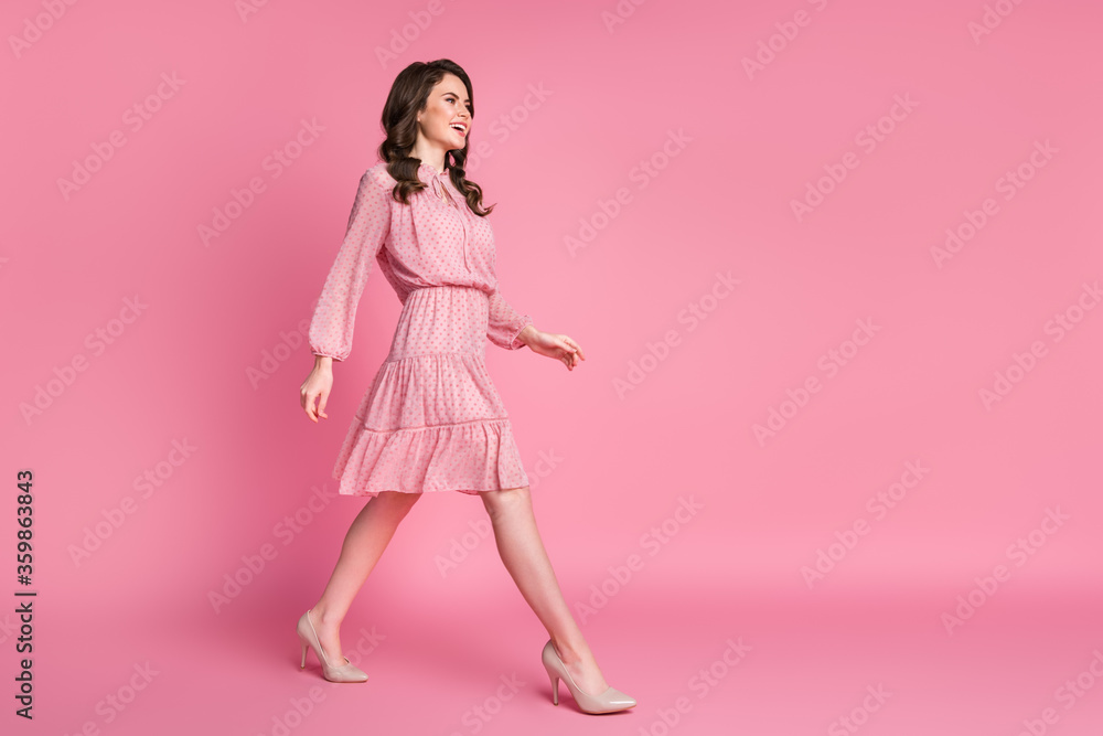 Full size profile side photo of candid content girl go walk step copyspace enjoy weekend holiday wear good look clothes isolated over pastel color background Full size profile side photo of candid content girl go walk step copyspace enjoy weekend holiday wear good look clothes isolated over pastel color background