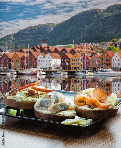 Typical Scandinavian sandwiches against Bryggen street with boats in Bergen, UNESCO World Heritage Site, Norway photo