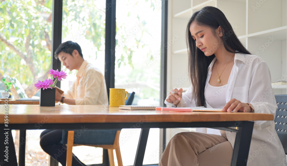 Women and men work in the Cafe.They sit in social distancing. Women and men work in the Cafe.They sit in social distancing.