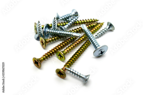 A set of various chromed screws isolated on white background photo