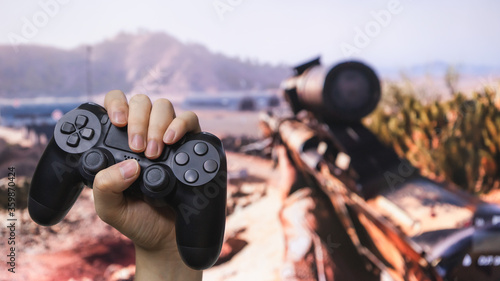 Fotografie Man hand holding joystick while playing the game.