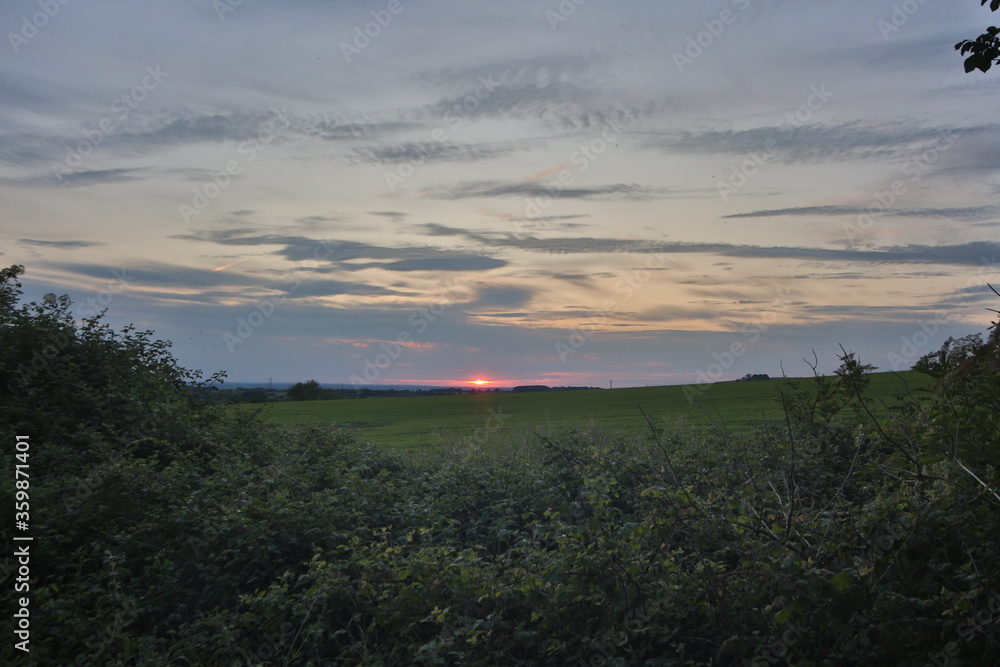 Obraz premium Sunset over fields