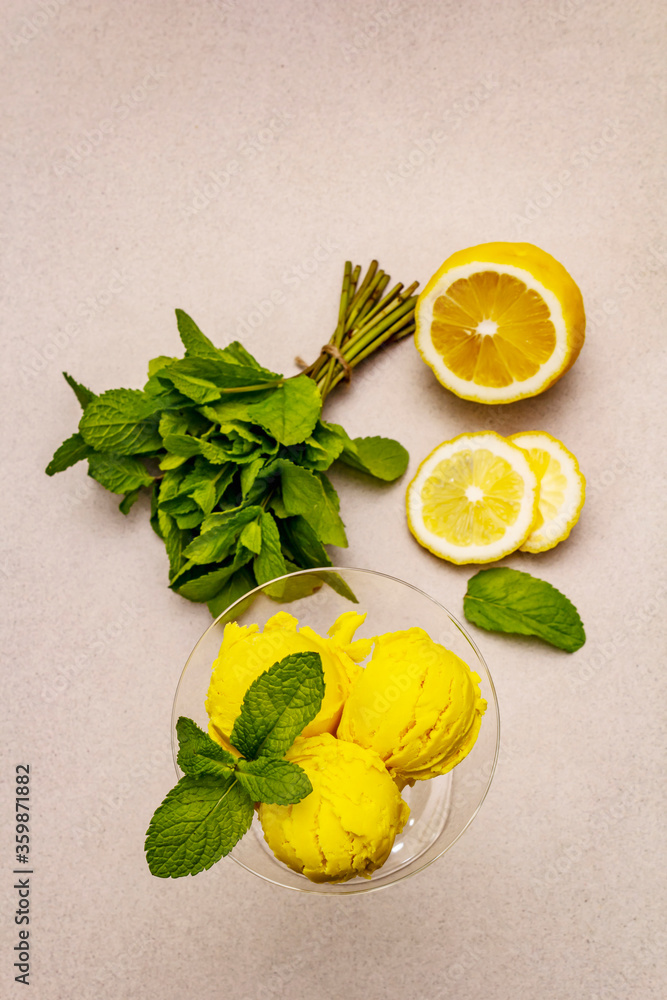Lemon ice cream with mint. Refreshing summer dessert, ripe fruit, fragrant leaves - obrazy, fototapety, plakaty 