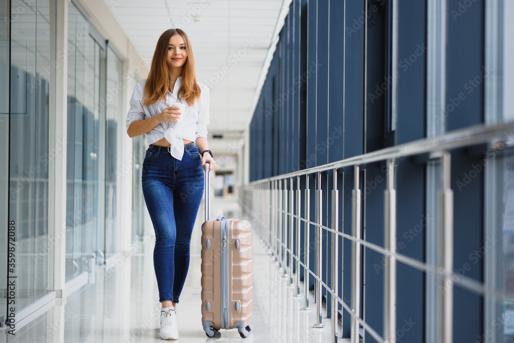 Pretty young female passenger at the airport (shallow DOF; color toned image)