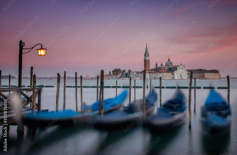 Gondolas on the edge of the grand Canal Venice at sunset. View from San Marco ( St Marks ) square looking to San Giorgio