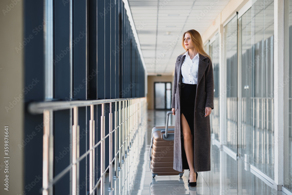 Portrait of successful business woman traveling with case at airport. Beautiful stylish female travel with luggage. Portrait of successful business woman traveling with case at airport. Beautiful stylish female travel with luggage.