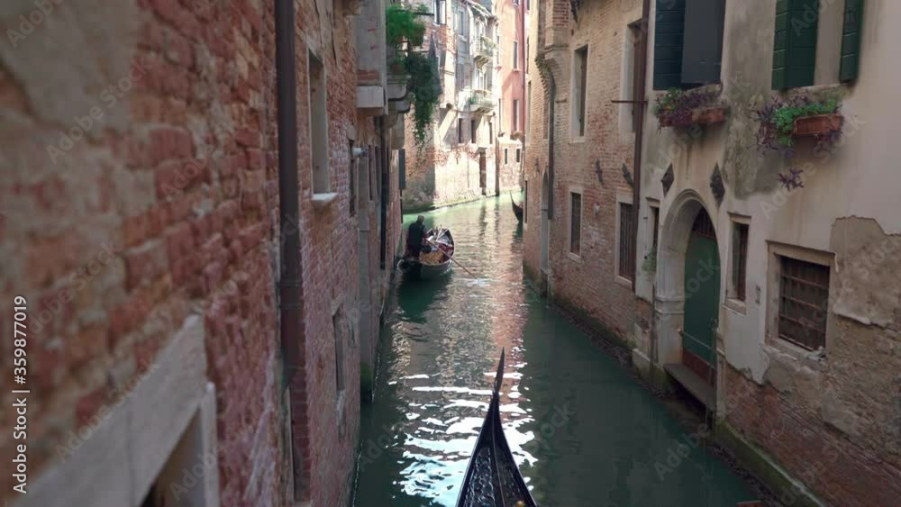 Gondolas sailing on a quiet canal of Venice.