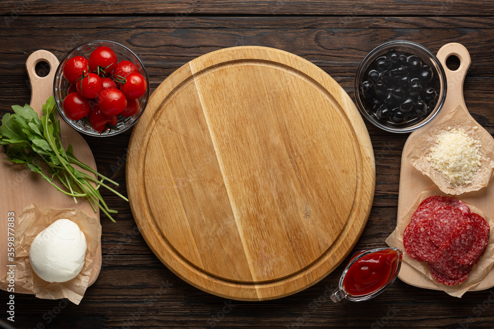 Process of making homemade pizza with mozzarella olives and salami, top view Process of making homemade pizza with mozzarella olives and salami, top view
