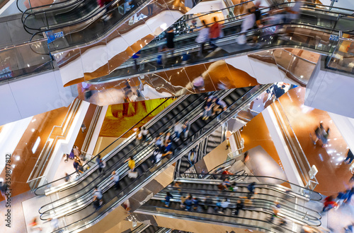 Bild auf Leinwand People on many fast moving Escalators In big modern shopping mall
