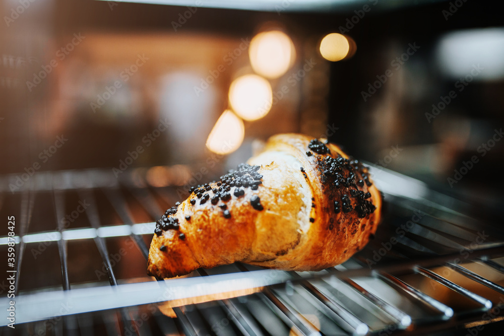 The last Fresh fragrant croissant on the counter in the bakery in the early morning a great