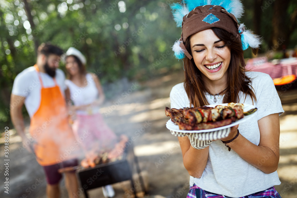 Group of happy young friends having barbecue party, outdoors Group of happy young friends having barbecue party, outdoors