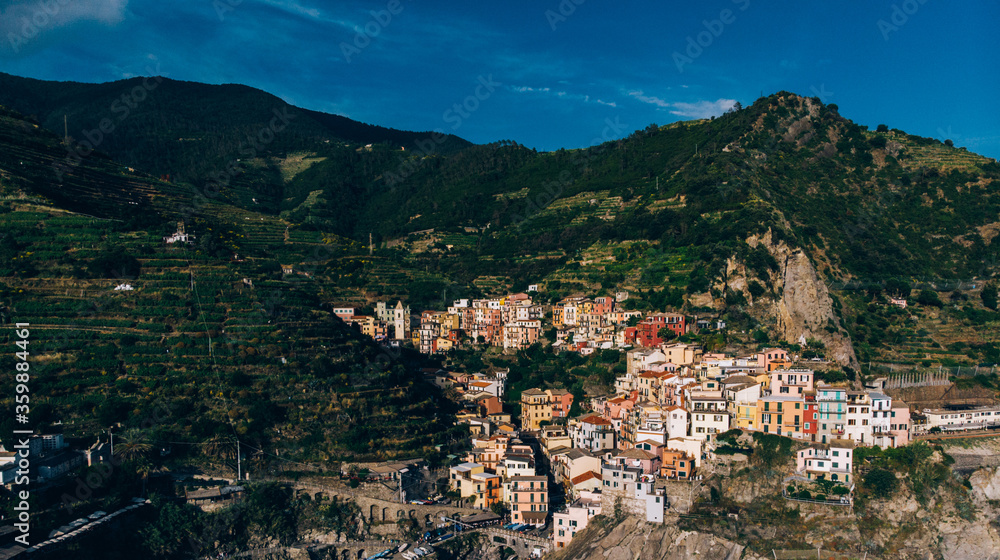 Aerial view of colourful village Manarola included in the list of famous picturesque villages on seashore of Italy with name Cinque Terre. Popular Mediterranean destination