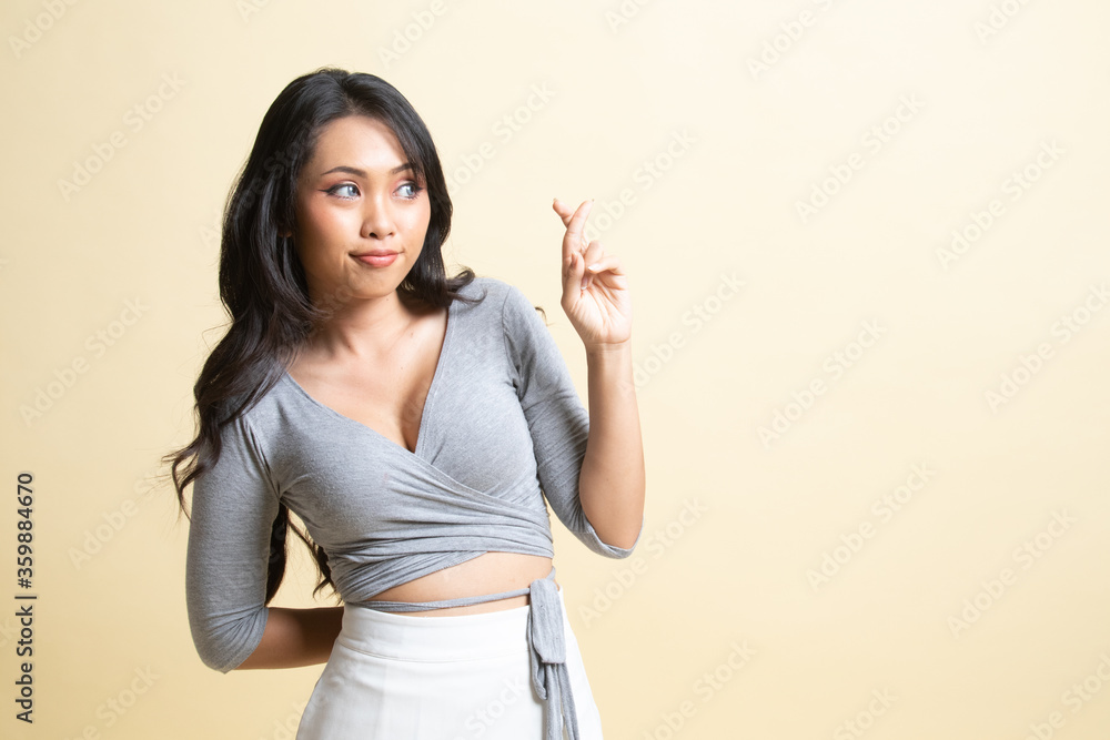 Beautiful young Asian woman cross finger. Beautiful young Asian woman cross finger.