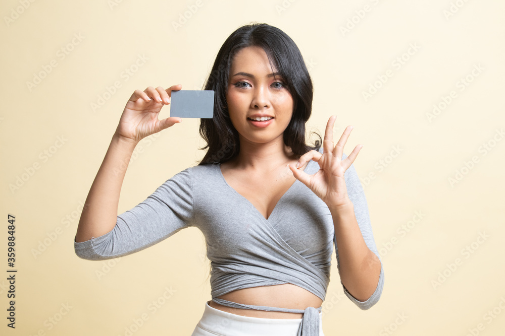 Young Asian woman show OK with a blank card. Young Asian woman show OK with a blank card.