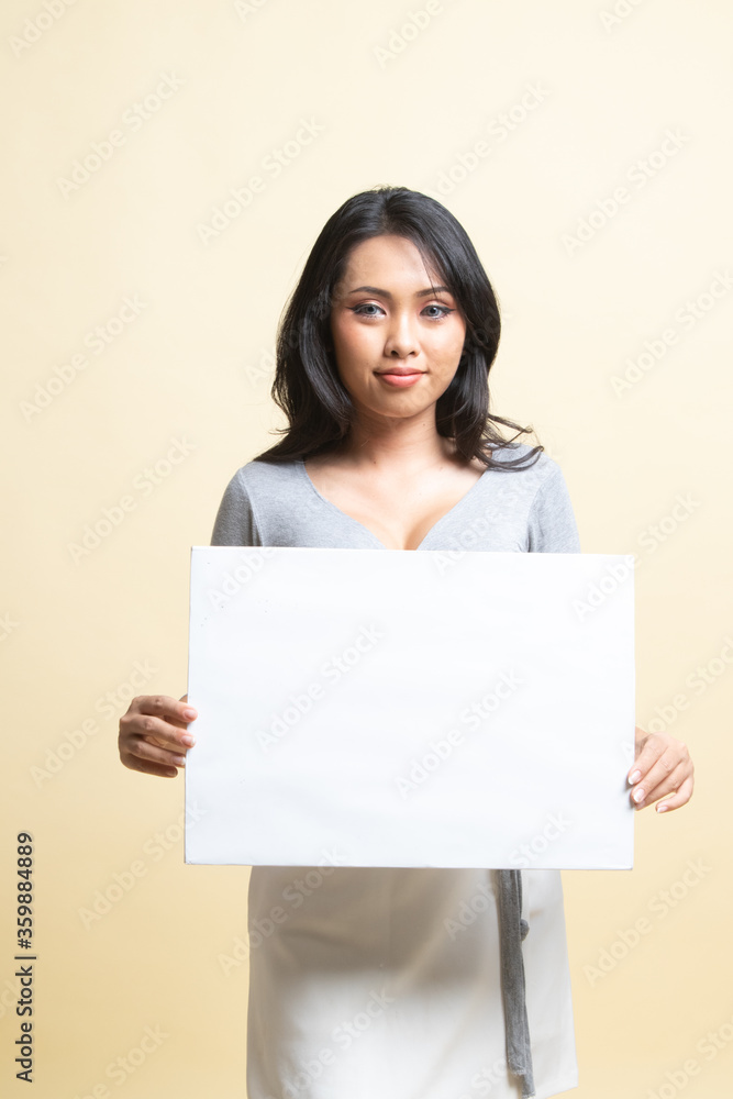 Young Asian woman with white blank sign. Young Asian woman with white blank sign.