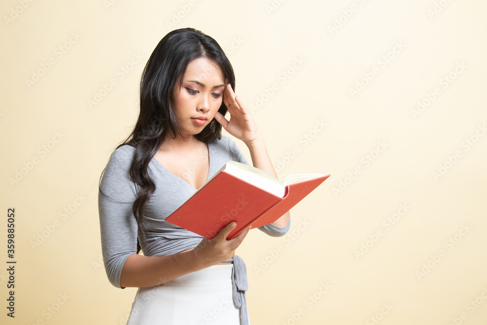 Young Asian woman got headache read a book. Young Asian woman got headache read a book.