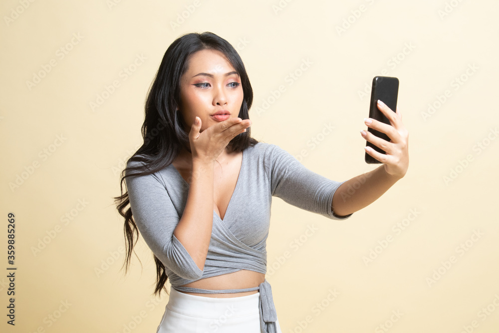 Young Asian woman with mobile phone. Young Asian woman with mobile phone.