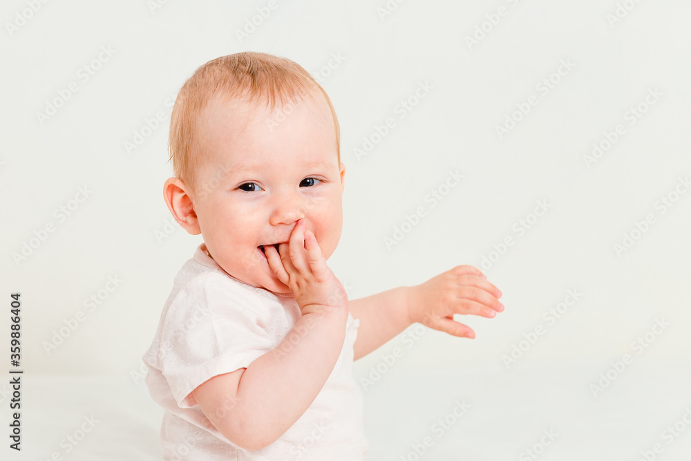 Baby in T-shirt sucking fingers on white background Baby in T-shirt sucking fingers on white background