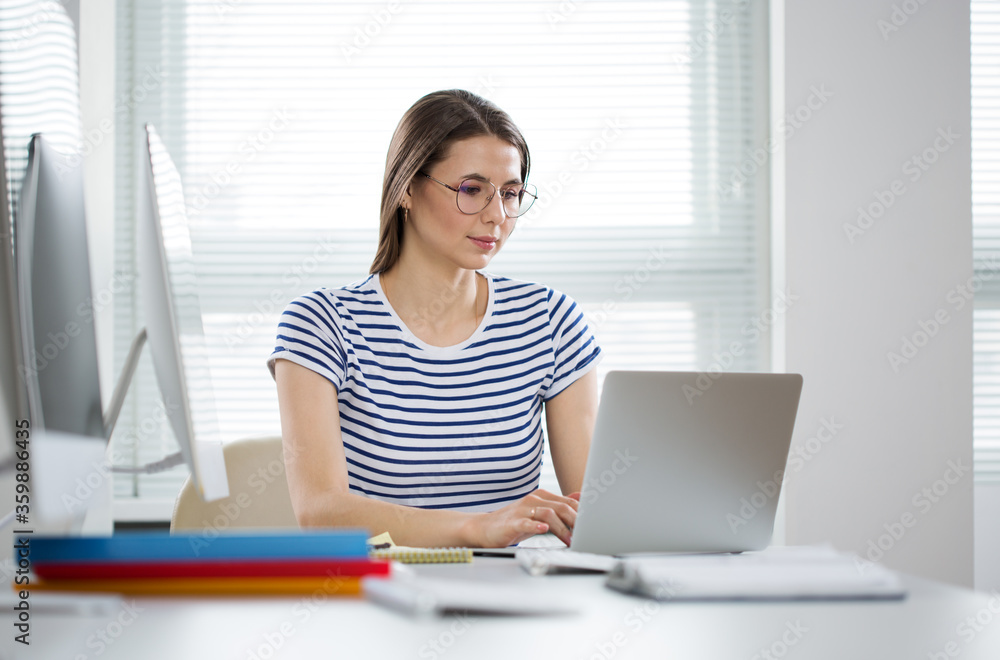 A business woman working alone in an empty office A business woman working alone in an empty office