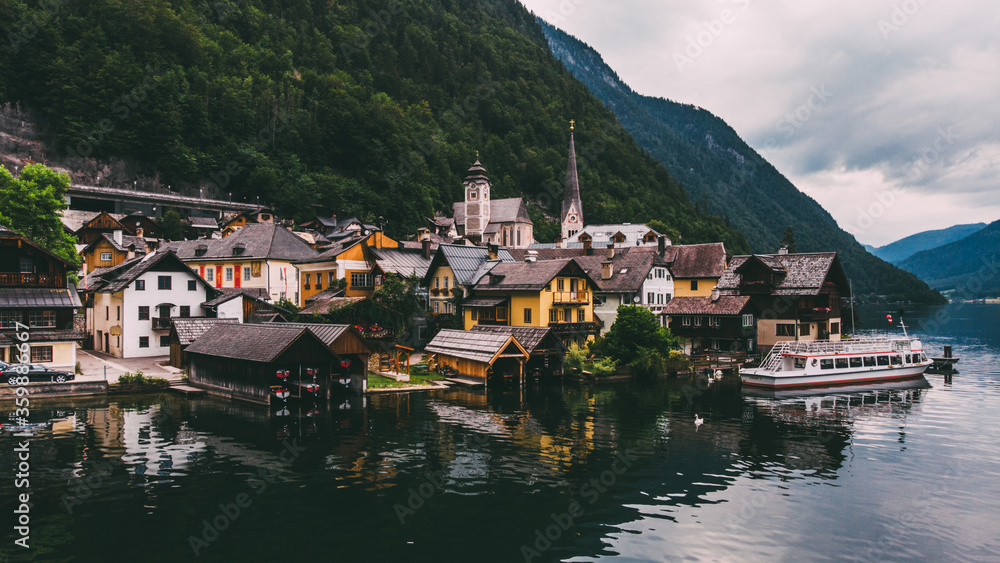 Scenery aerial view of famous Hallstatt town on lake shore in mountains. Salzkammergut resort under the protection of UNESCO situated Hallstätter See, Alpine village in Austria