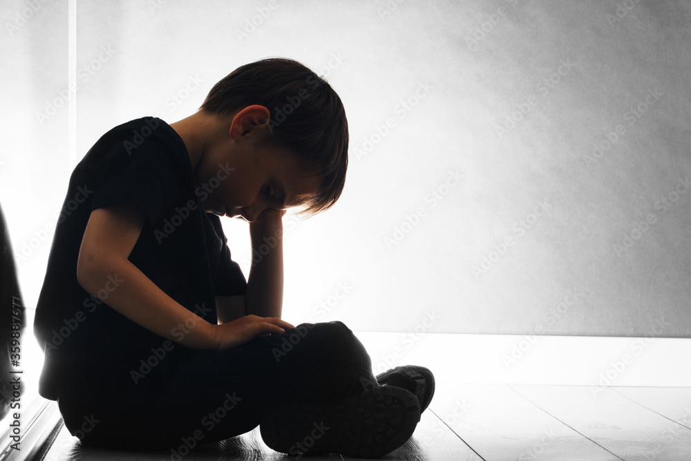 child with depression is sitting on the floor child with depression is sitting on the floor
