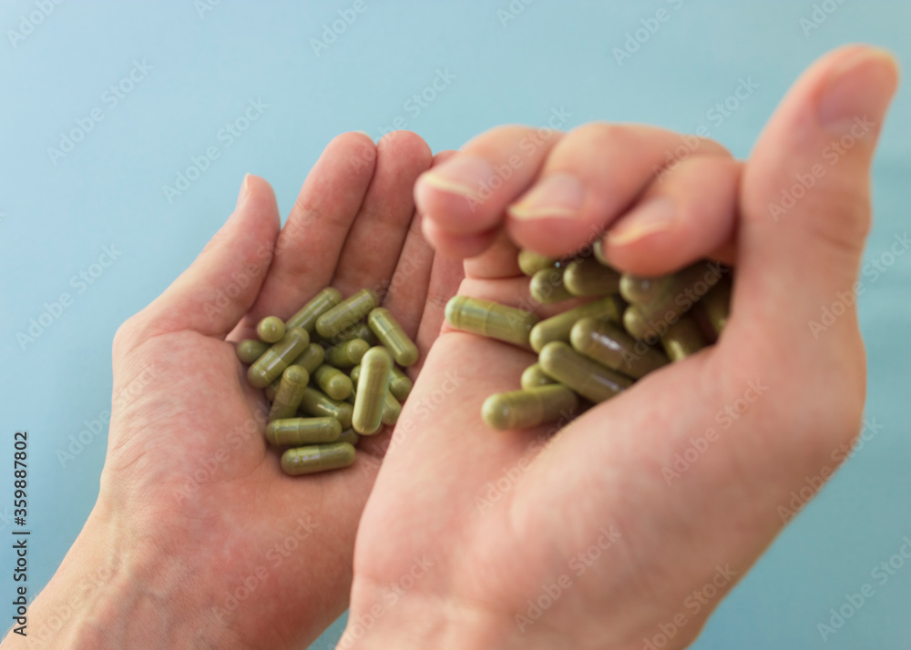 Chlorella in capsules super food. vegetable dietary Supplement Chlorella.capsules in hands top view