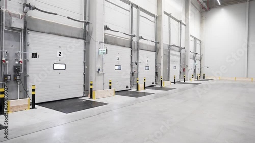 Inside the warehouse, loading docks- clean empty logistic center 