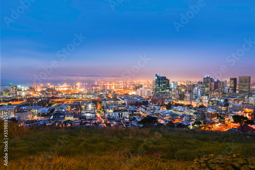 Cape Town city CBD skyline illuminated at night with blue sky