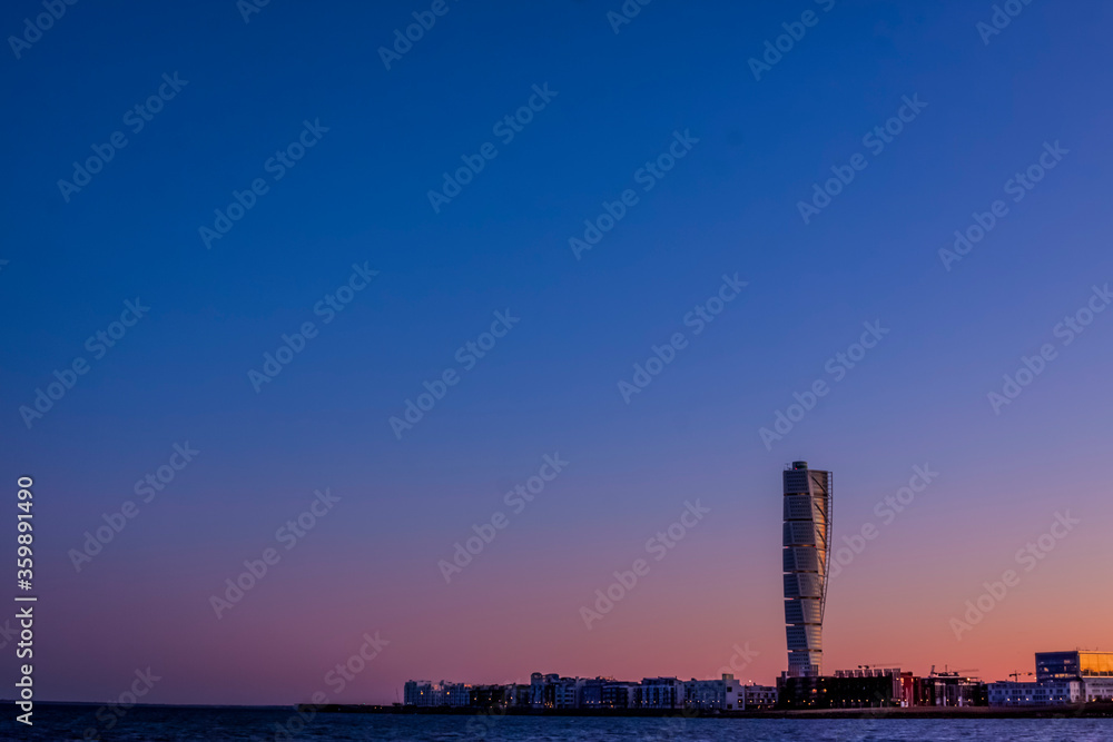Naklejka premium The skyscraper, Turning torso, in Malmo Sweden, the largest building in Scandinavia, in sunset