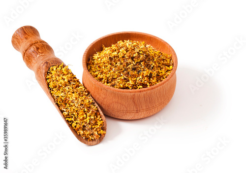 Osmanthus "Fragrant Flower" Tea in the wooden scoop and  wooden bowl  isolated on a white background.