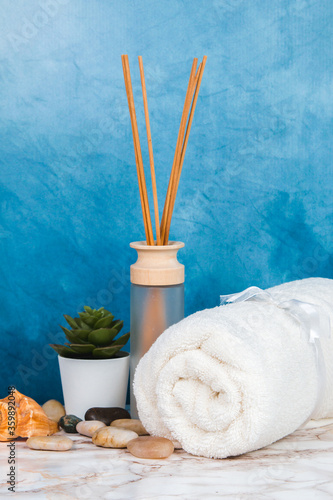 Spa objects and elements on a marble table and blue background