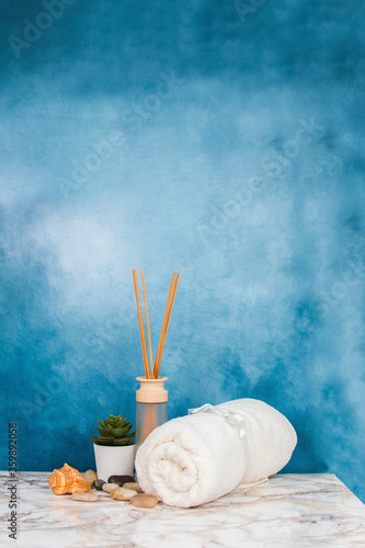 Spa objects and elements on a marble table and blue background
