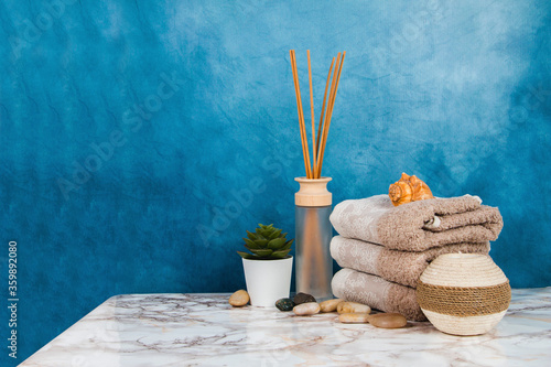 Spa objects and elements on a marble table and blue background
