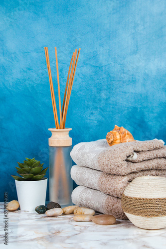Spa objects and elements on a marble table and blue background