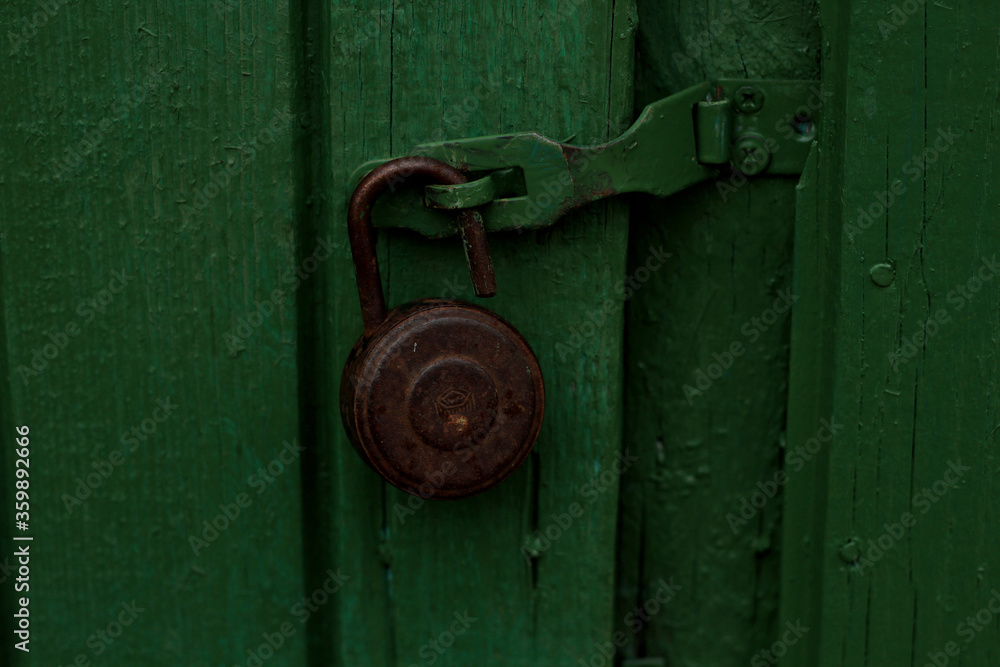 The old lock on the green door. Macro shooting of the lock on the green door The old lock on the green door. Macro shooting of the lock on the green door