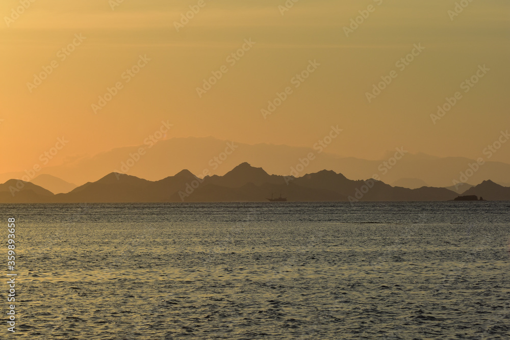 Sunset over the sea with mountains silhouette, Komodo Island, Labuan Bajo, East Nusa Tenggara, Indonesia