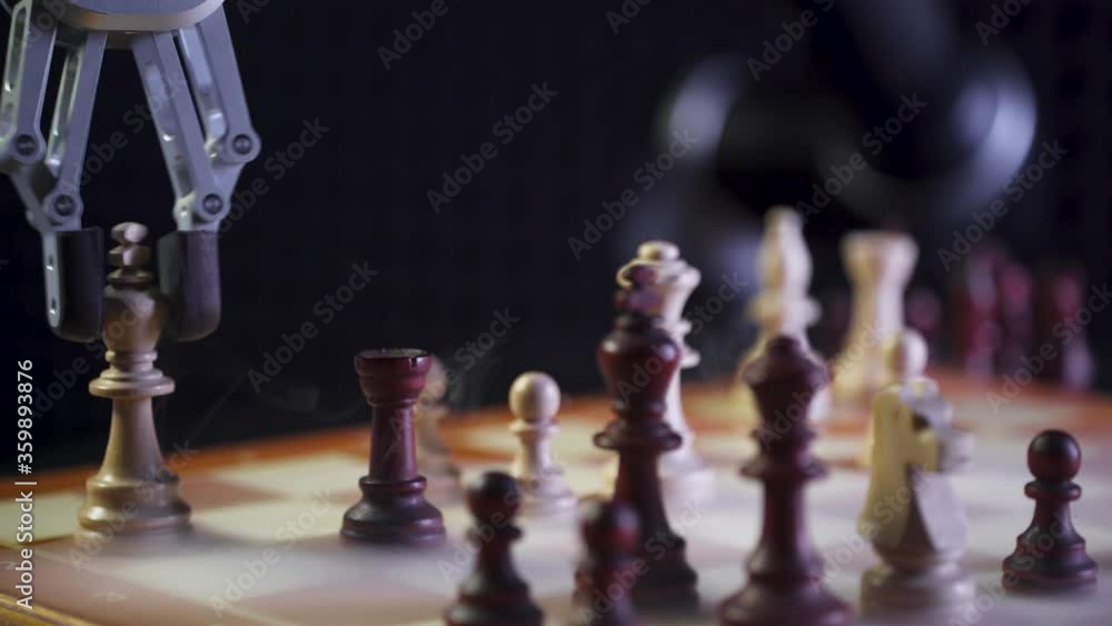 Robot playing chess with a man, artificial intelligence, checkmate, futuristic robotic arm participates in the game, smoke effect, close-up. Robot playing chess with a man, artificial intelligence, checkmate, futuristic robotic arm participates in the game, smoke effect, close-up.