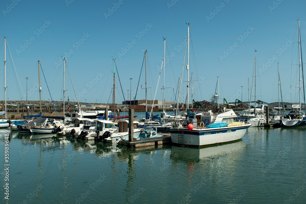 View of Newhaven Marina view of boats and yachts at moorings on a warm and sunny summers day on the the South Coast of England.